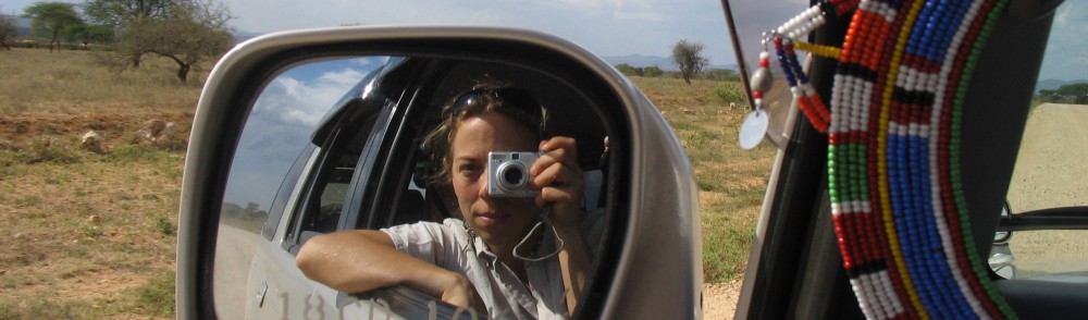 amanda euringer in the mirror of a car with Africa in the background